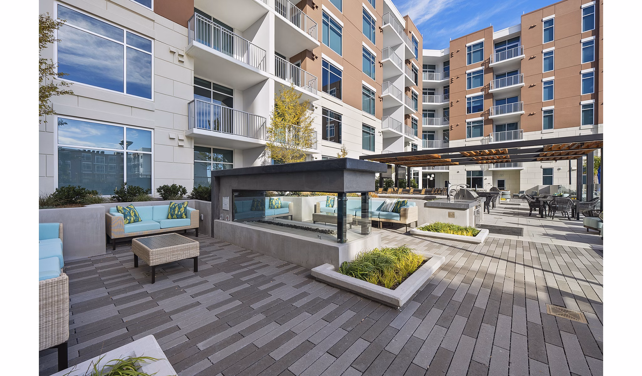 Community pool and fire pit at Element SouthPark Apartments with luxurious seating and ambient lighting to enhance outdoor relaxation