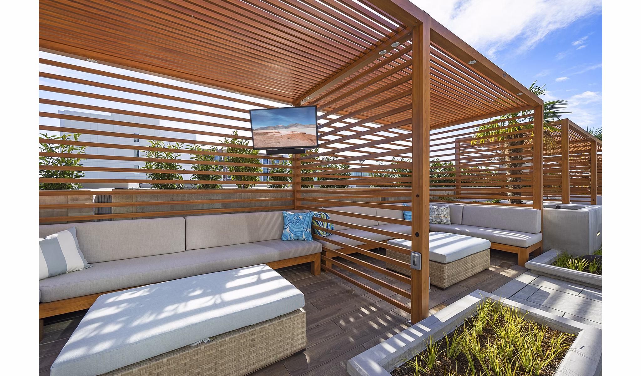 Pool patio with lounge chairs and greenery at Element SouthPark luxury apartments