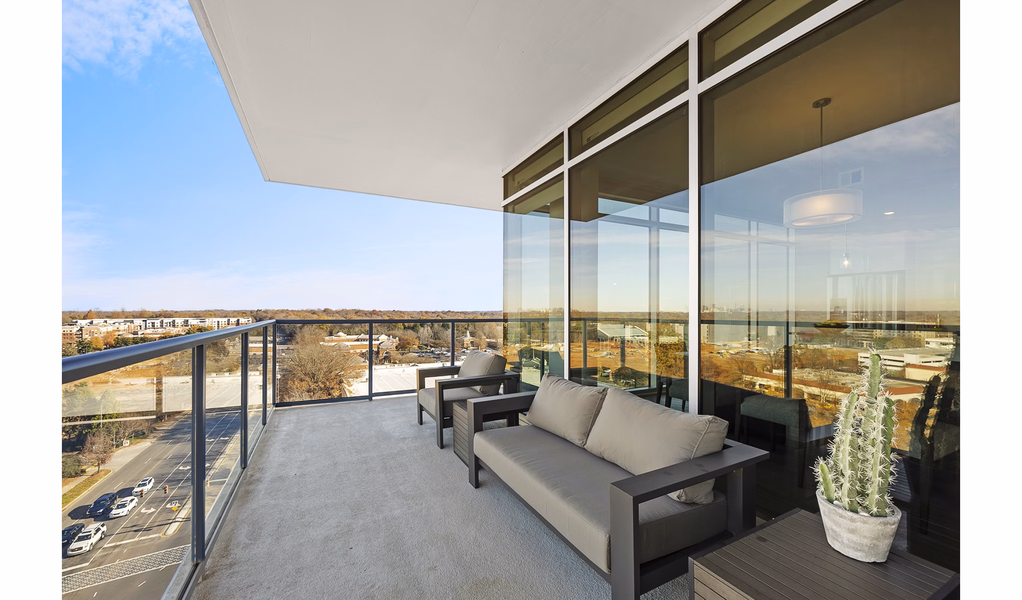 Private balcony overlooking lush courtyard at Element SouthPark Apartments