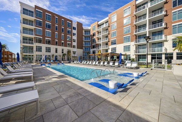 Sparkling outdoor pool at Element SouthPark Apartments with lush surroundings