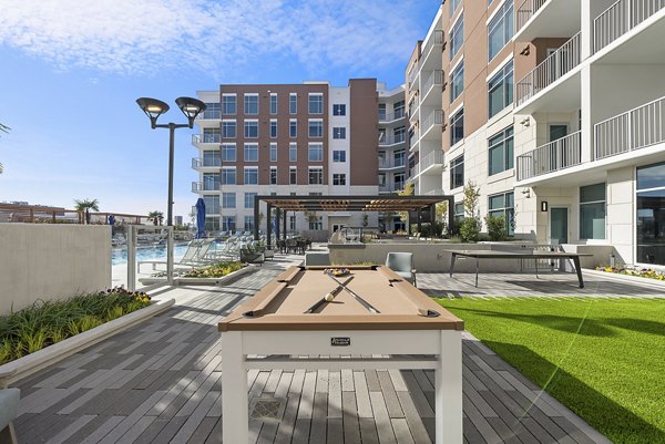 Outdoor sport courts at Element SouthPark Apartments featuring tennis and basketball facilities in a picturesque setting