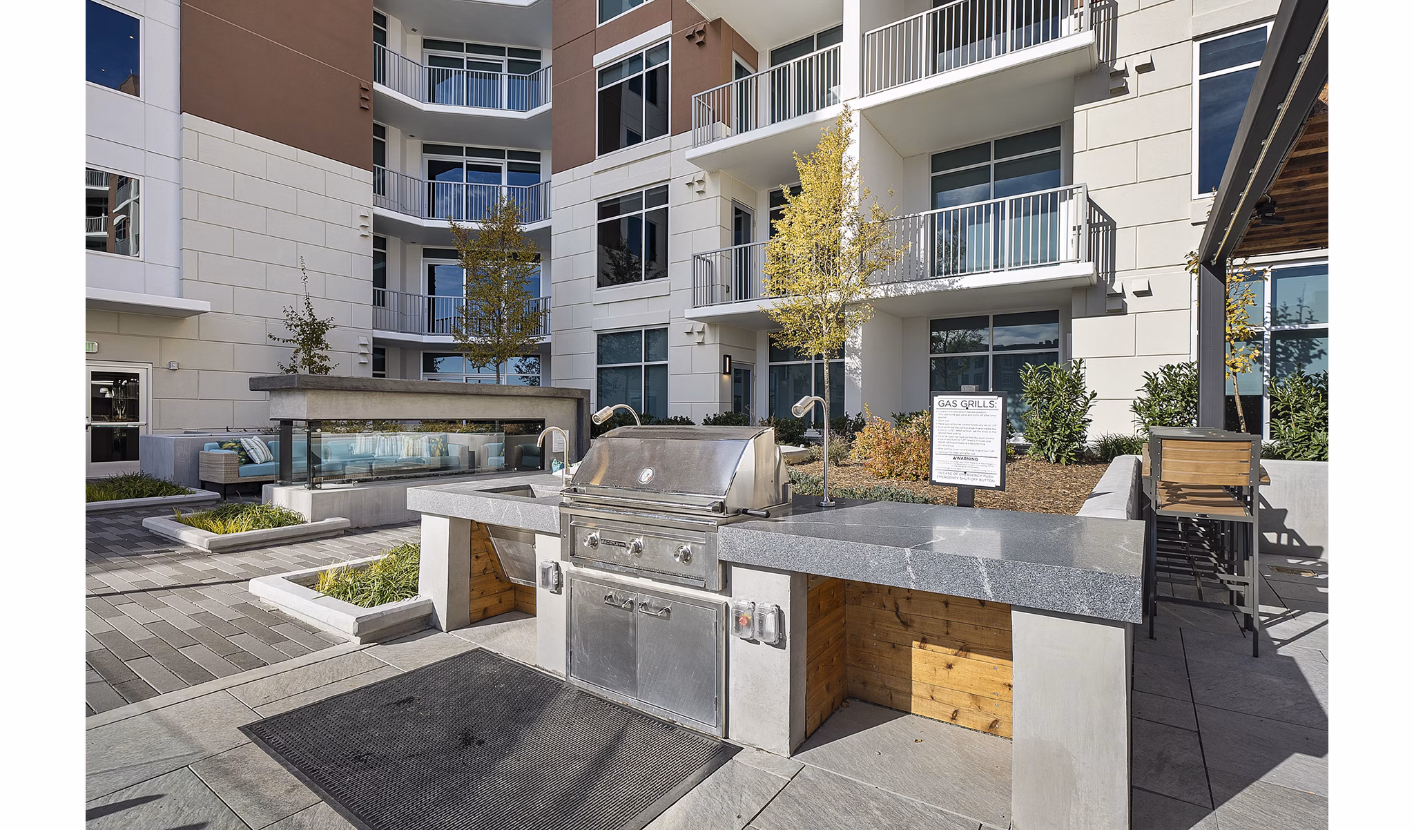 Outdoor grill area with modern seating at Element SouthPark Apartments, ideal for hosting gatherings and enjoying the outdoors