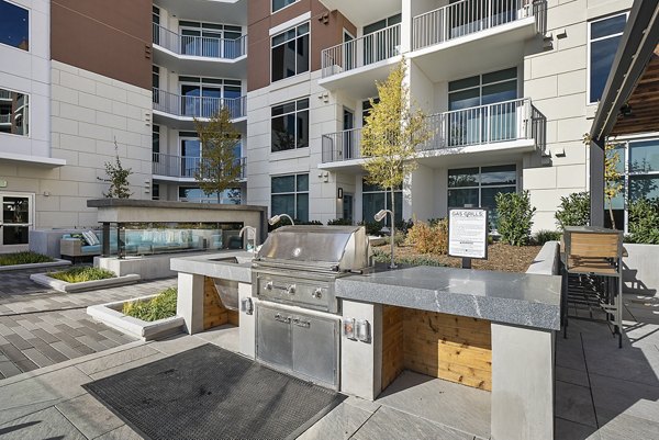 Outdoor grill area with modern seating at Element SouthPark Apartments, ideal for hosting gatherings and enjoying the outdoors