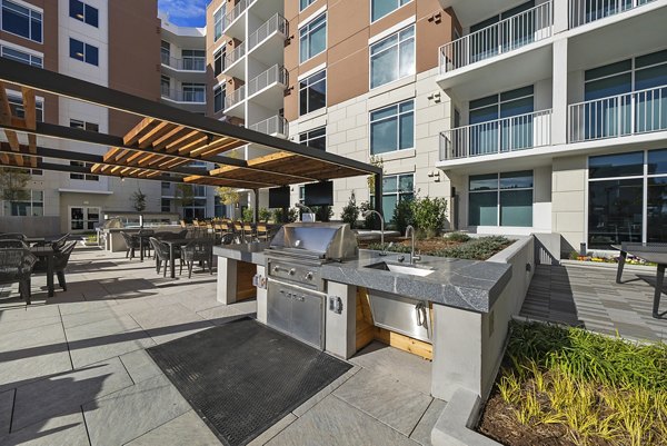 Spacious outdoor grill area with modern seating at Element SouthPark Apartments, ideal for entertaining and relaxation