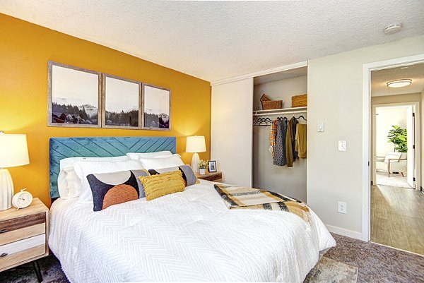Cozy bedroom with modern decor and large windows at Miro Apartments