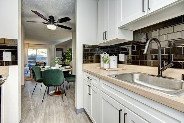 Kitchens featuring sleek cabinetry and modern appliances at Miro Apartments