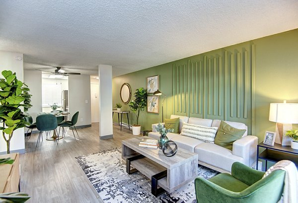 Spacious living room with stylish furnishings and natural light in Miro Apartments