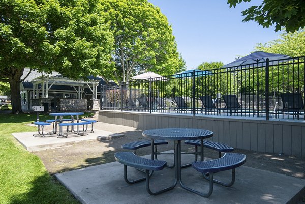 Outdoor grill area on a spacious patio at Miro Apartments, ideal for social gatherings and relaxation in a luxurious setting