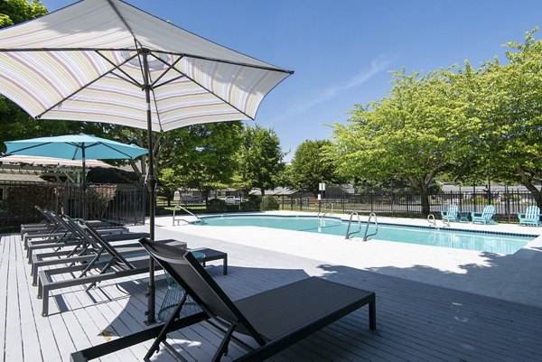 Resort-style pool with lounge chairs at Miro Apartments, luxury complex in vibrant location