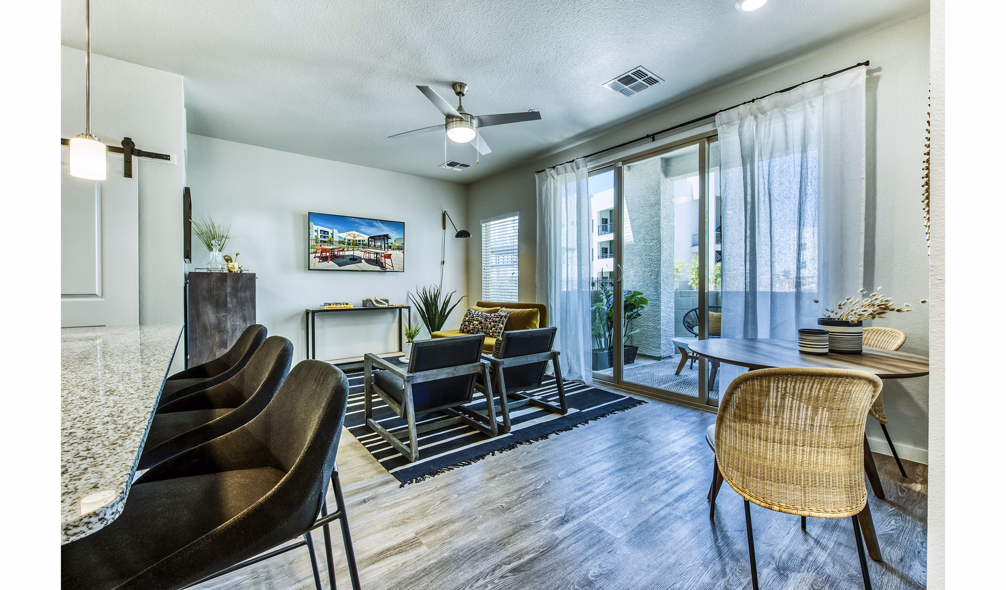 Contemporary living room with modern furnishings at Amiya Apartments, a Greystar community