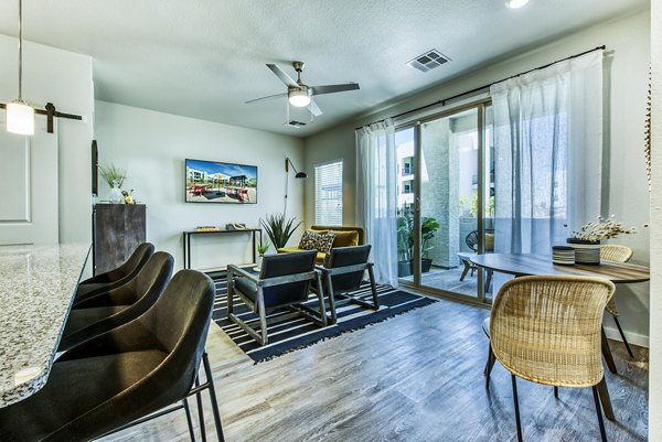 Contemporary living room with modern furnishings at Amiya Apartments, a Greystar community