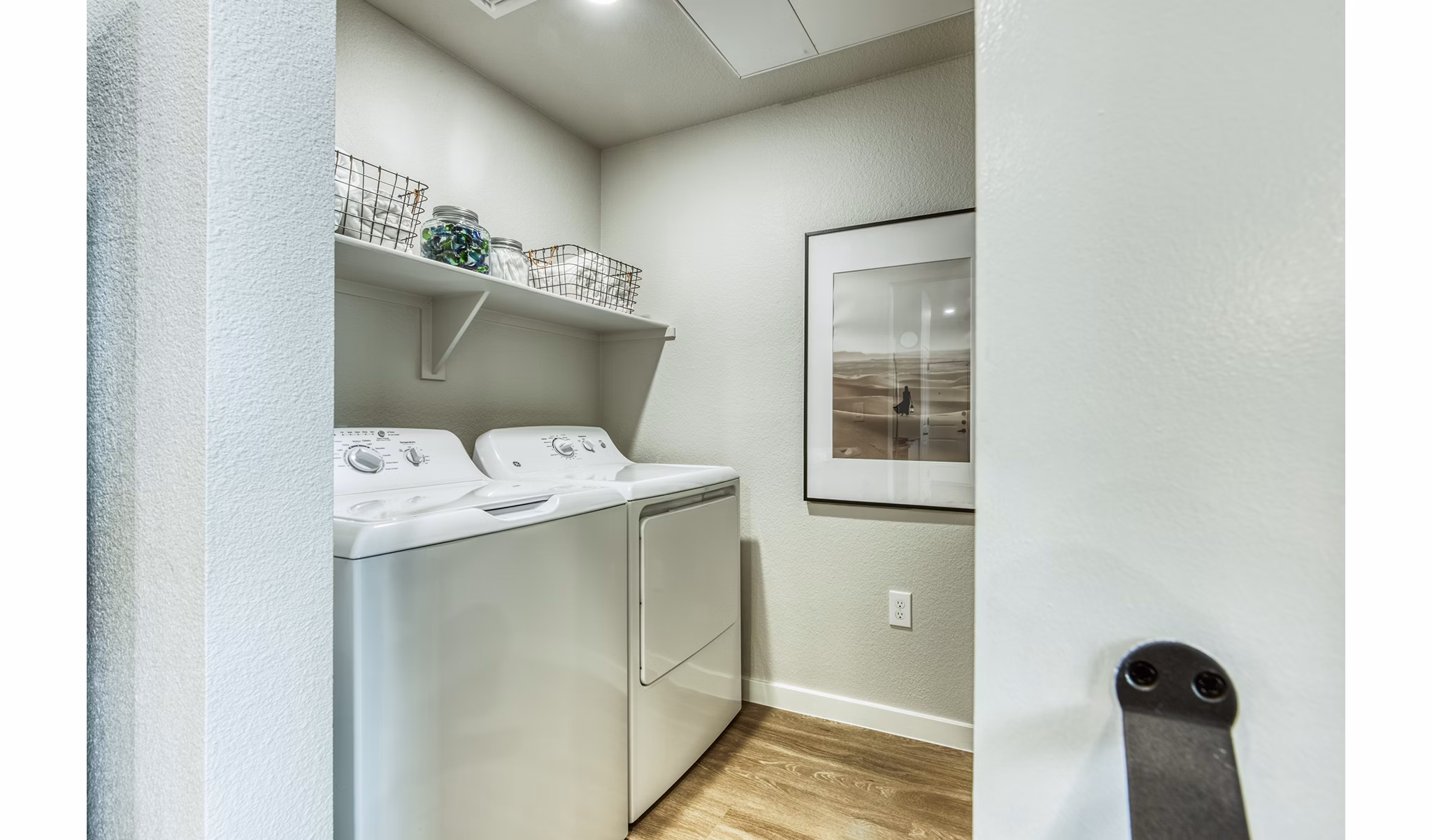 Modern laundry room with stainless steel appliances at Amiya Apartments