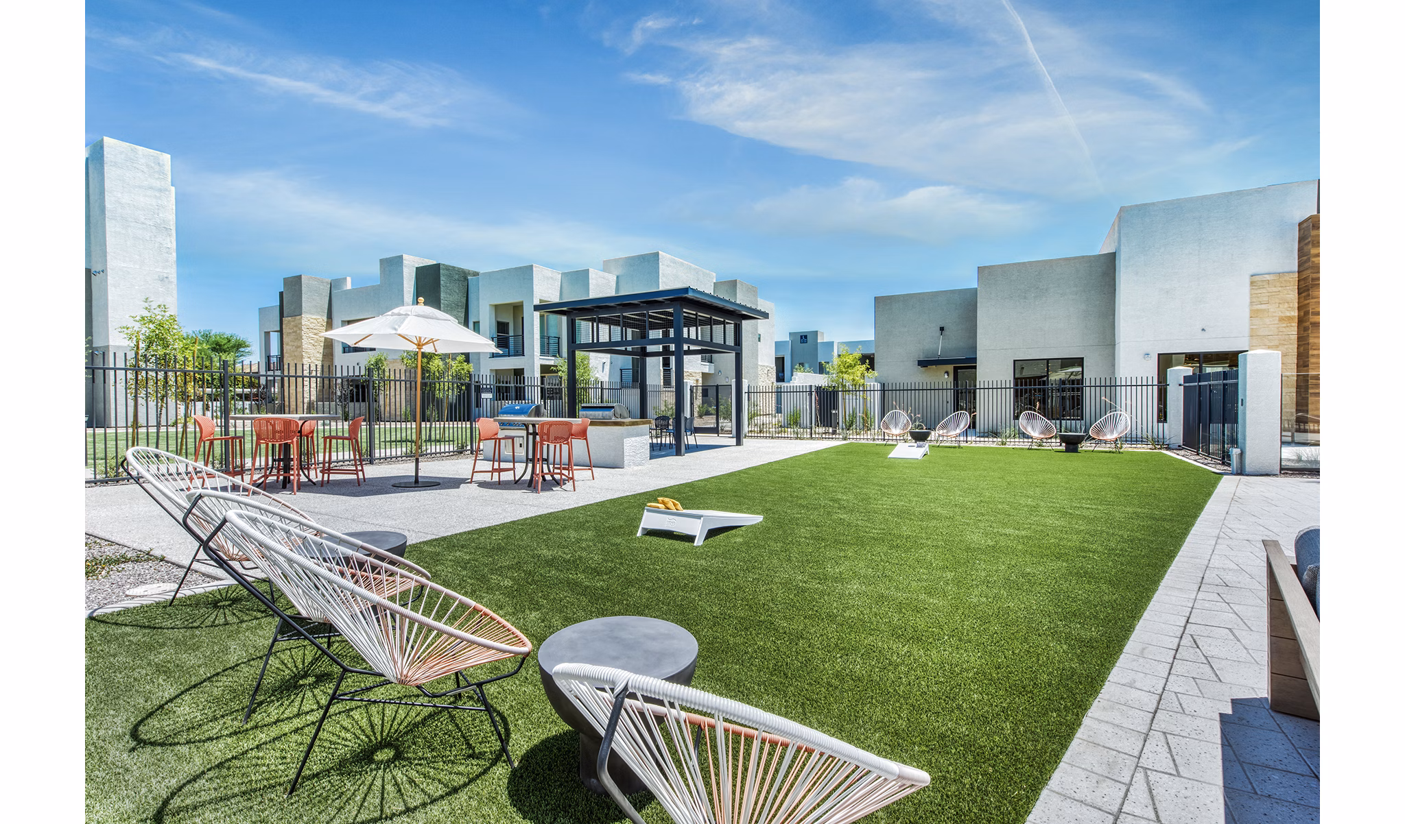 Amiya Apartments: Inviting recreational area with lush greenery and seating for relaxation and socializing