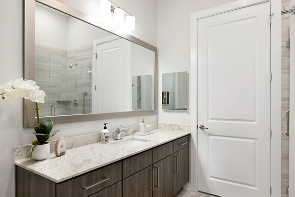 Modern bathroom featuring sleek fixtures and spacious vanity at Overture Cary Apartments