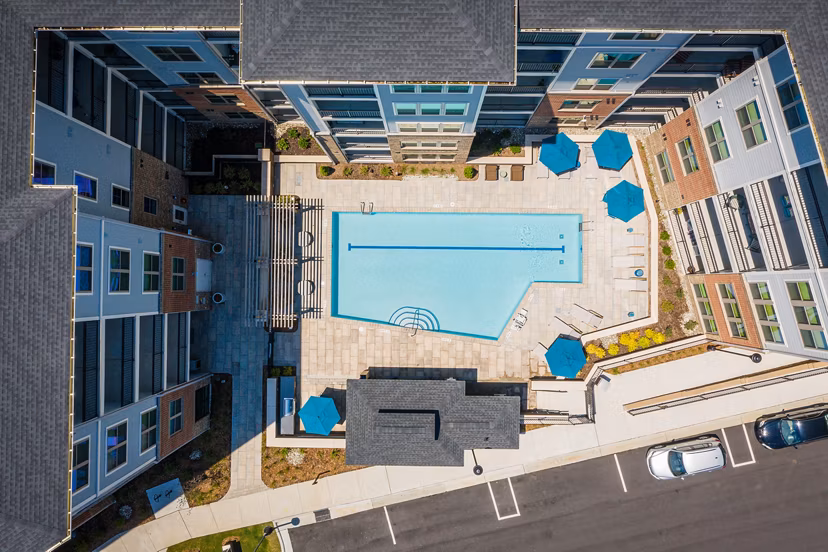 Rooftop pool with sun loungers at Overture Cary Apartments offering luxury leisure for residents