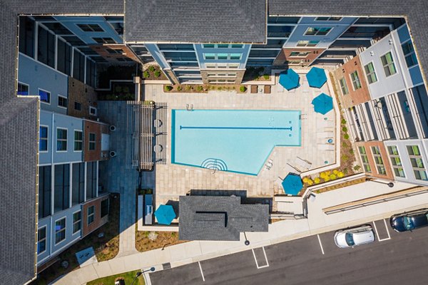 Rooftop pool with sun loungers at Overture Cary Apartments offering luxury leisure for residents