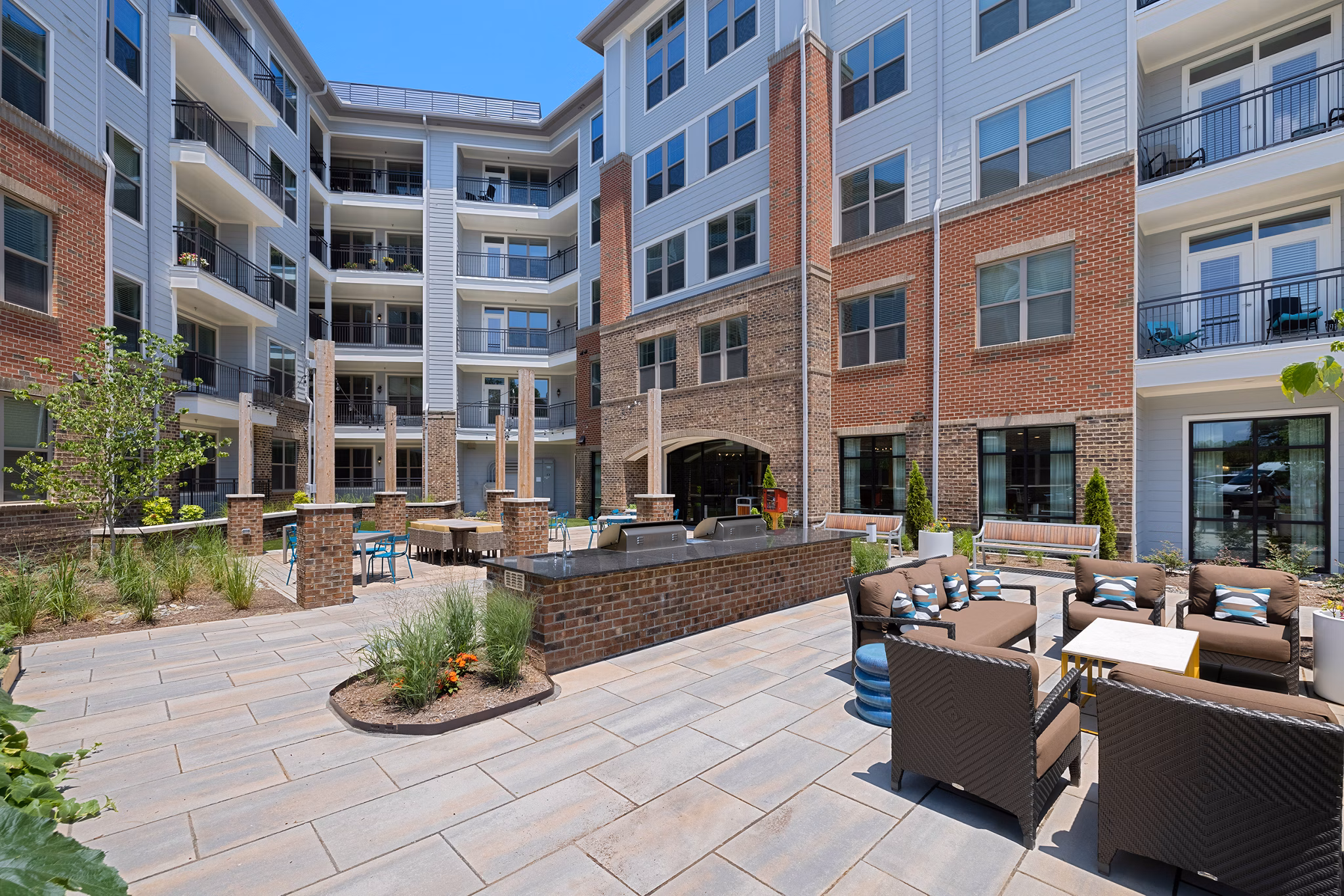 Courtyard with lush landscaping and seating at Overture Cary Apartments, designed for luxury living and relaxation