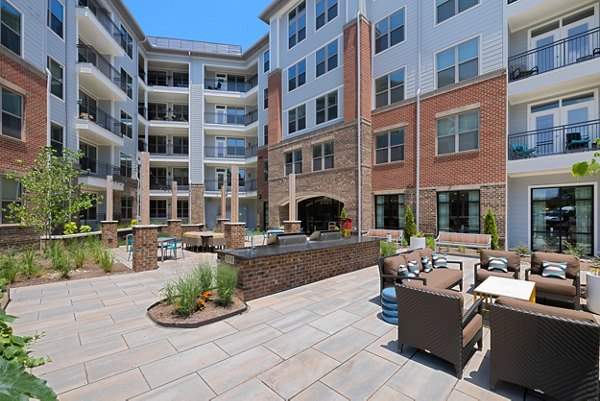 Courtyard with lush landscaping and seating at Overture Cary Apartments, designed for luxury living and relaxation