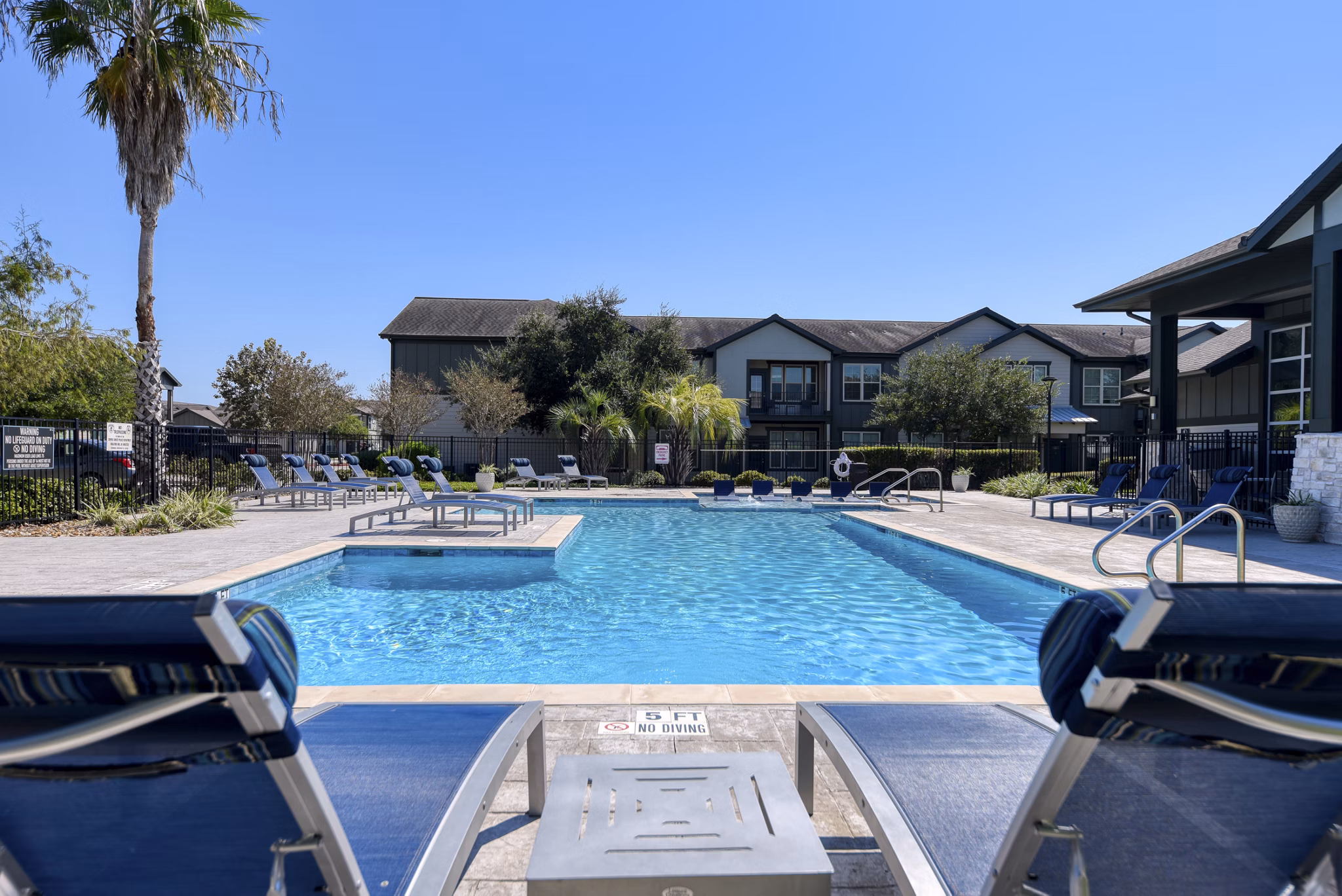 Rooftop pool with sun loungers at Sage Apartments in a luxury setting