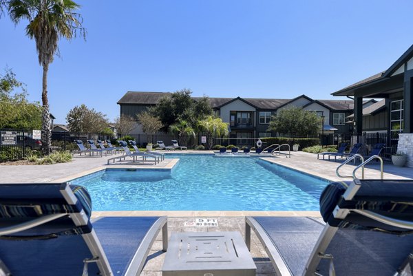 Rooftop pool with sun loungers at Sage Apartments in a luxury setting