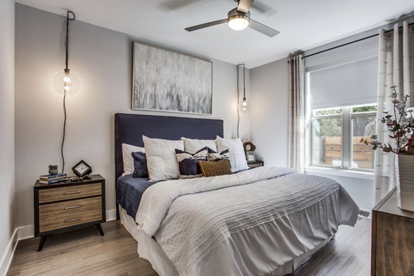 Modern bedroom with sleek furnishings at Trailhead Apartments, a luxury Greystar community