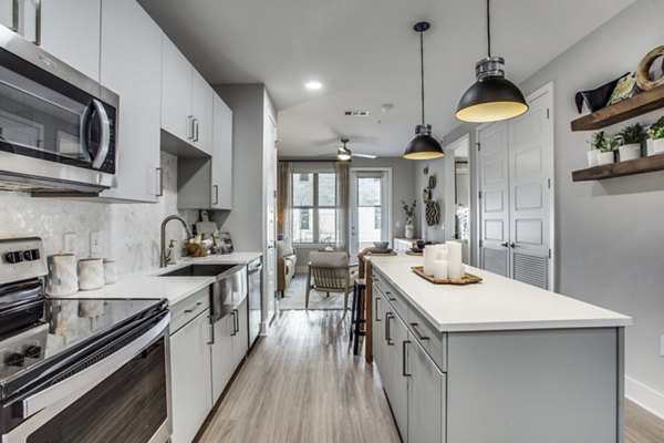 Modern kitchen with stainless steel appliances at Trailhead Apartments