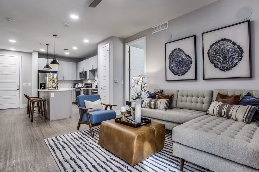 Trailhead Apartments: Modern living room with cozy seating and natural light, ideal for comfortable luxury living