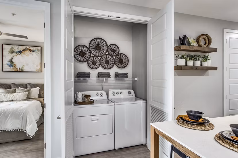 Laundry room with energy-efficient machines at Trailhead Apartments