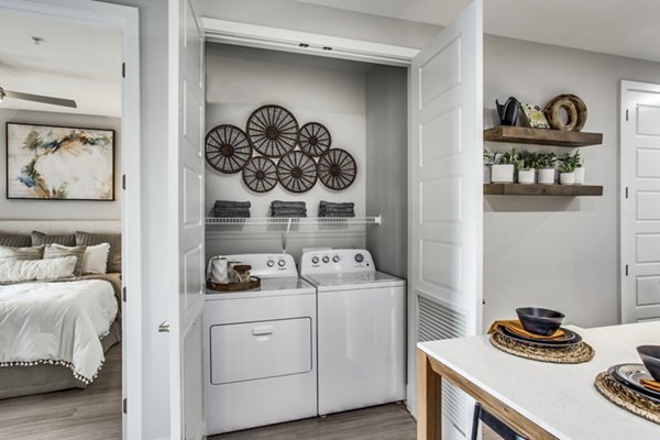 Laundry room with energy-efficient machines at Trailhead Apartments