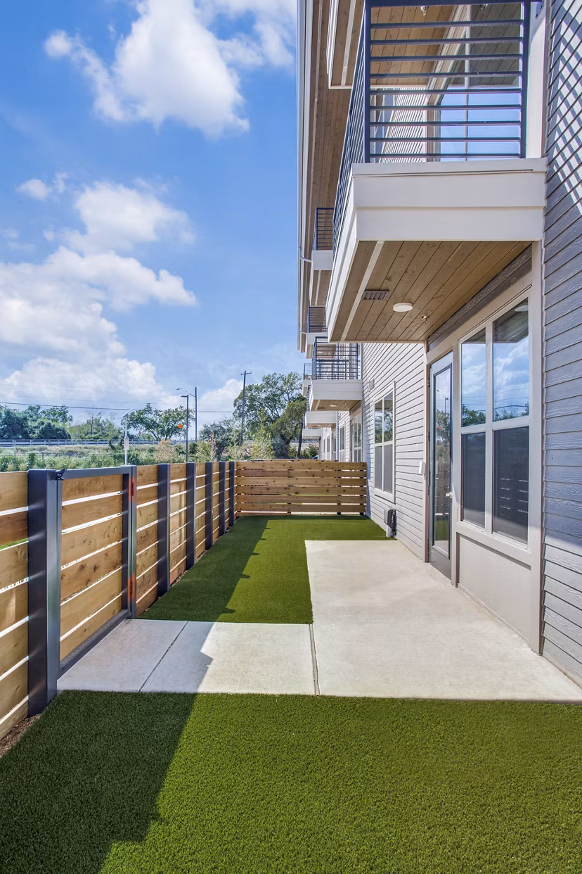 Trailhead Apartments: Cozy patio area with outdoor seating and modern landscaping in a luxury apartment community