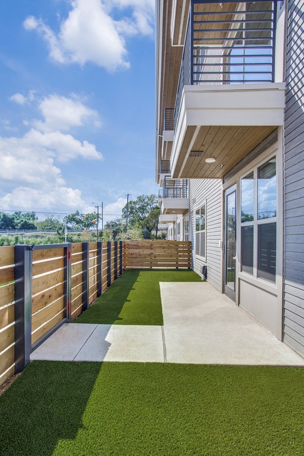 Trailhead Apartments: Cozy patio area with outdoor seating and modern landscaping in a luxury apartment community