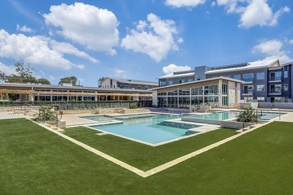 Luxurious outdoor pool at Trailhead Apartments offering relaxing lounge chairs and scenic views