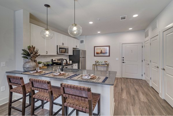 Modern kitchen with stainless steel appliances at Album Keller Ranch Apartments