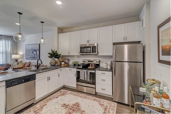 Modern kitchen with stainless steel appliances in Album Keller Ranch Apartments