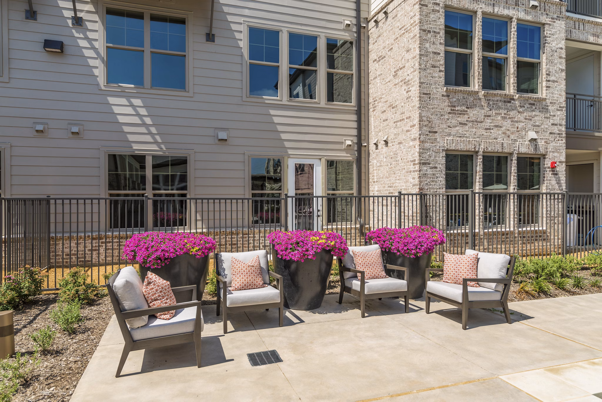Outdoor patio with comfortable seating at Album Keller Ranch Apartments in Keller, offering a relaxing social space for residents