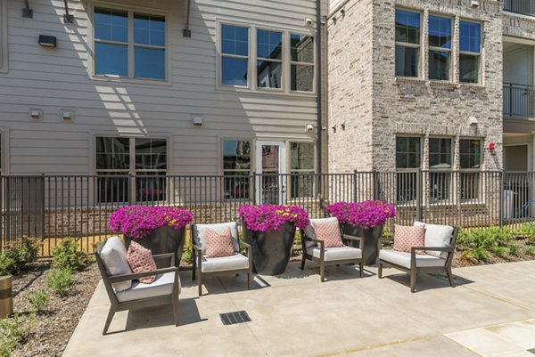 Outdoor patio with comfortable seating at Album Keller Ranch Apartments in Keller, offering a relaxing social space for residents