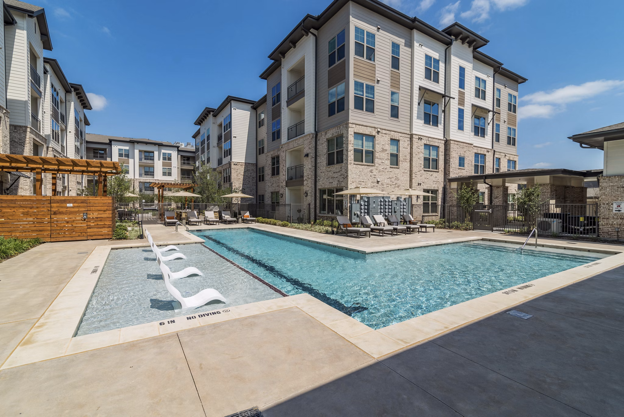 Relaxing pool area with lounge seating at Album Keller Ranch Apartments, perfect for outdoor enjoyment and leisure activities