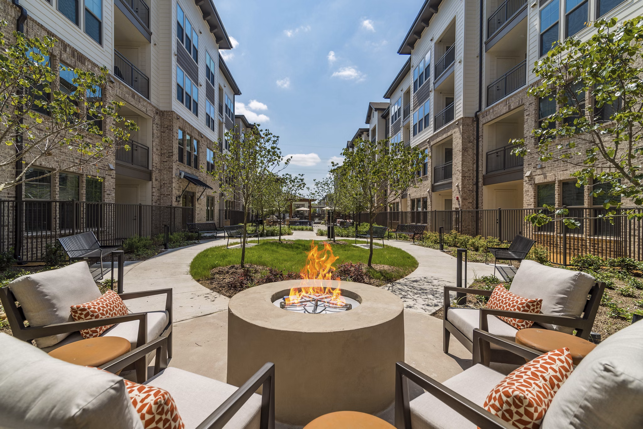 Fire pit area with cozy seating at Album Keller Ranch Apartments: Relaxing outdoor space for residents to unwind and socialize