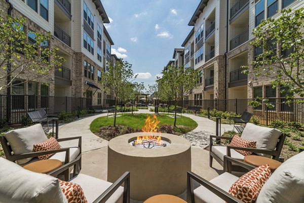 Fire pit area with cozy seating at Album Keller Ranch Apartments: Relaxing outdoor space for residents to unwind and socialize