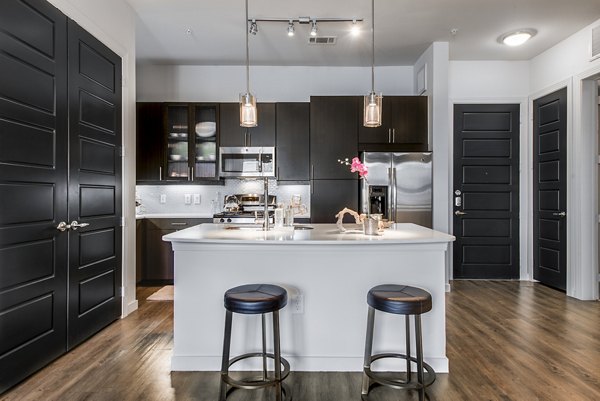 Modern kitchen with sleek countertops and stainless steel appliances at Mezzo Kirby Med Center Apartments