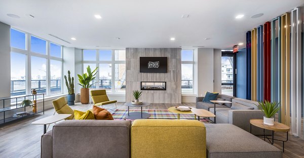 Clubhouse featuring modern design and bright seating areas at Ryder Apartments