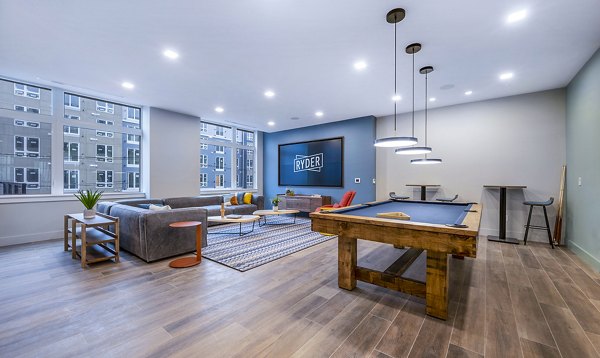 Clubhouse game room with billiards and seating at Ryder Apartments, luxury community apartments