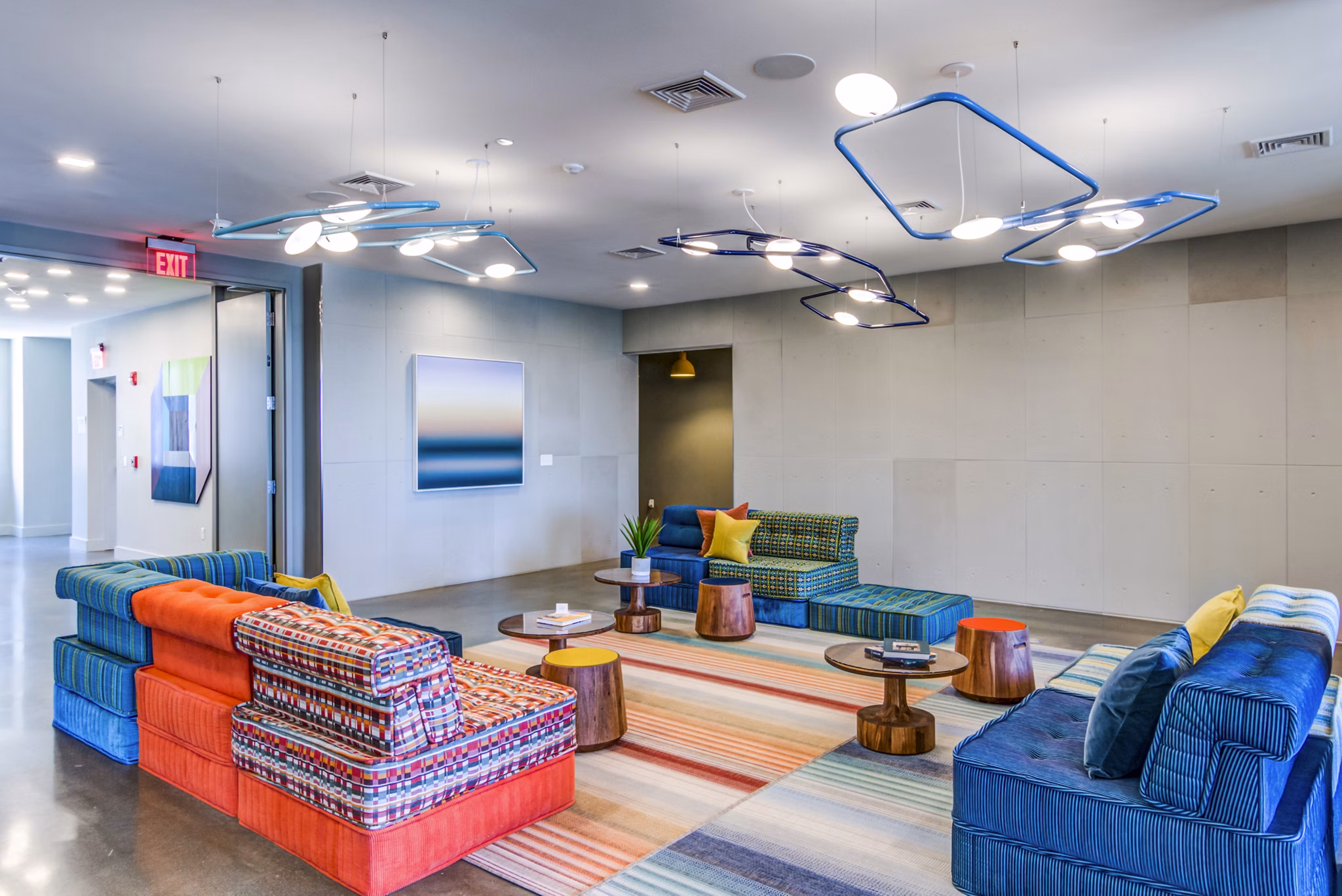 Clubhouse lounge with modern seating and billiards table at Ryder Apartments, offering luxury living and social spaces