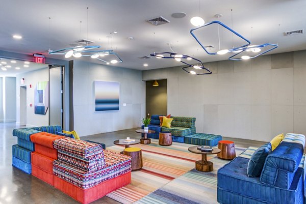 Clubhouse lounge with modern seating and billiards table at Ryder Apartments, offering luxury living and social spaces