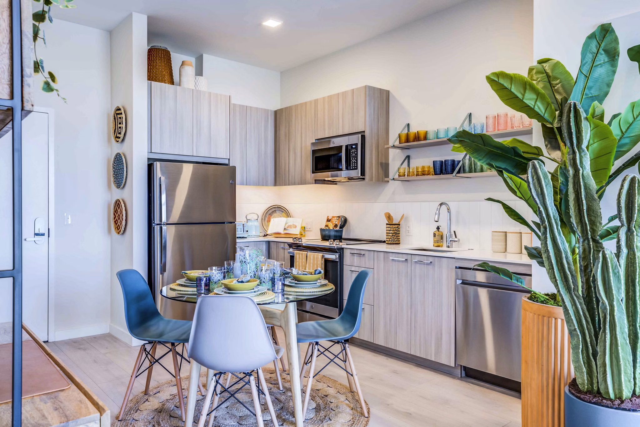 Modern kitchen/dining room with sleek cabinetry and stainless steel appliances at Ryder Apartments