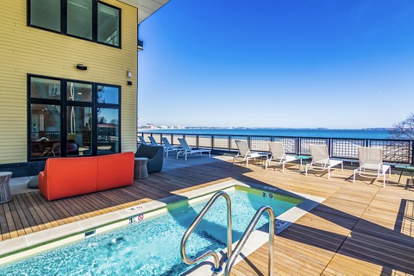 Rooftop pool with lounge chairs at Ryder Apartments featuring luxury amenities and panoramic skyline views