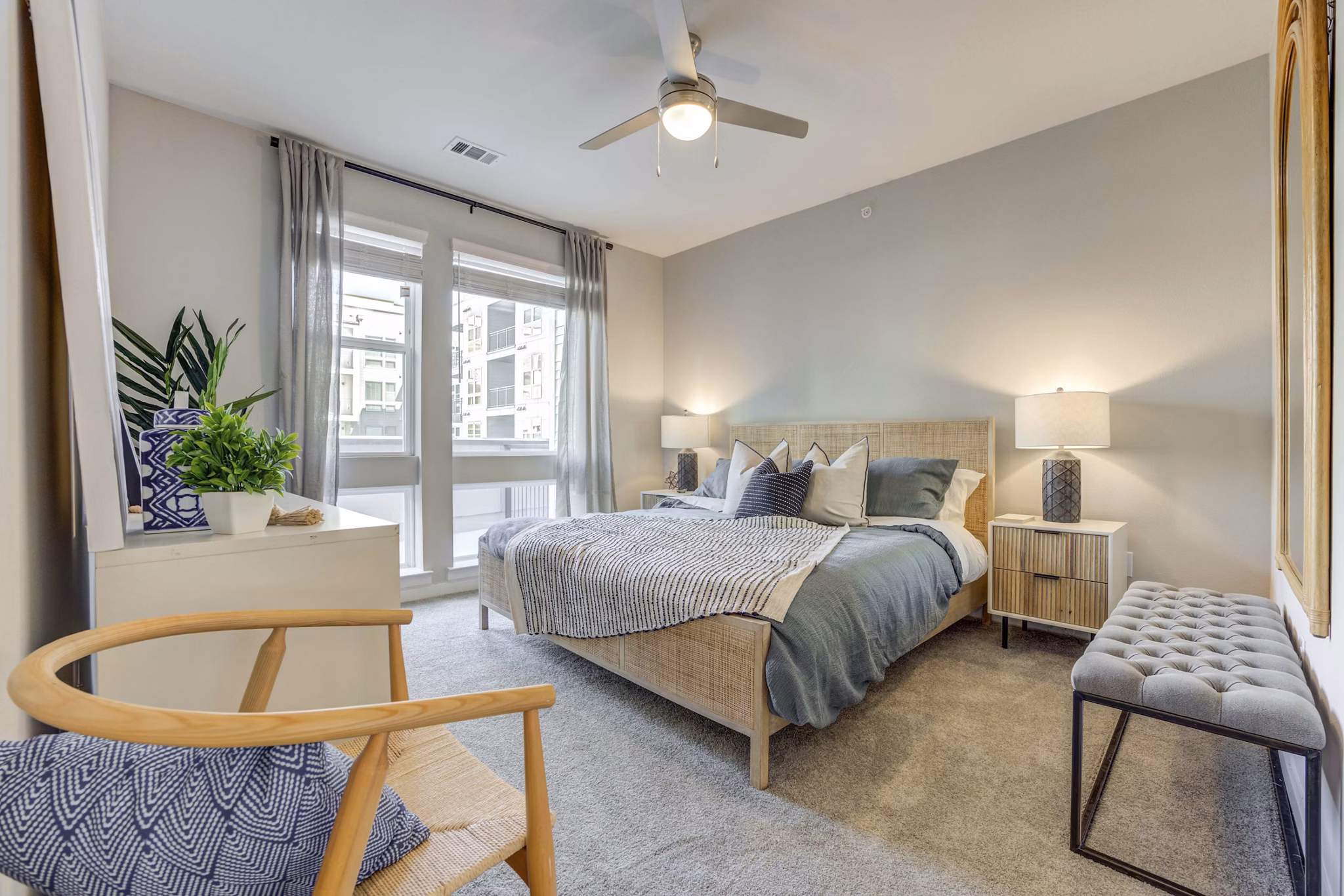 Bedroom with modern furnishings and ample natural light at Alder Apartments, luxury living in an inviting Greystar community