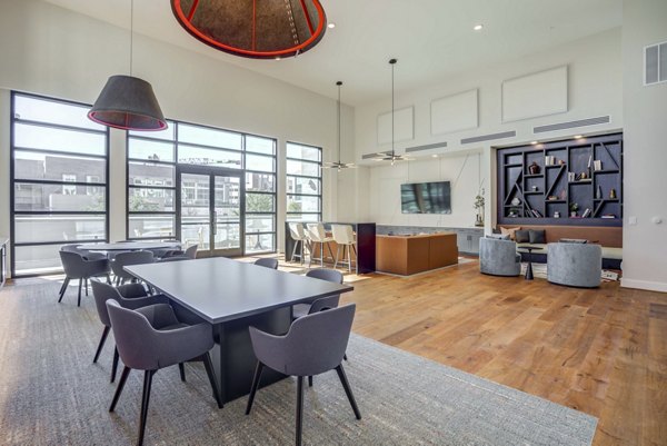 Elegant clubhouse with modern seating and large windows at Alder Apartments, perfect for community gatherings and events