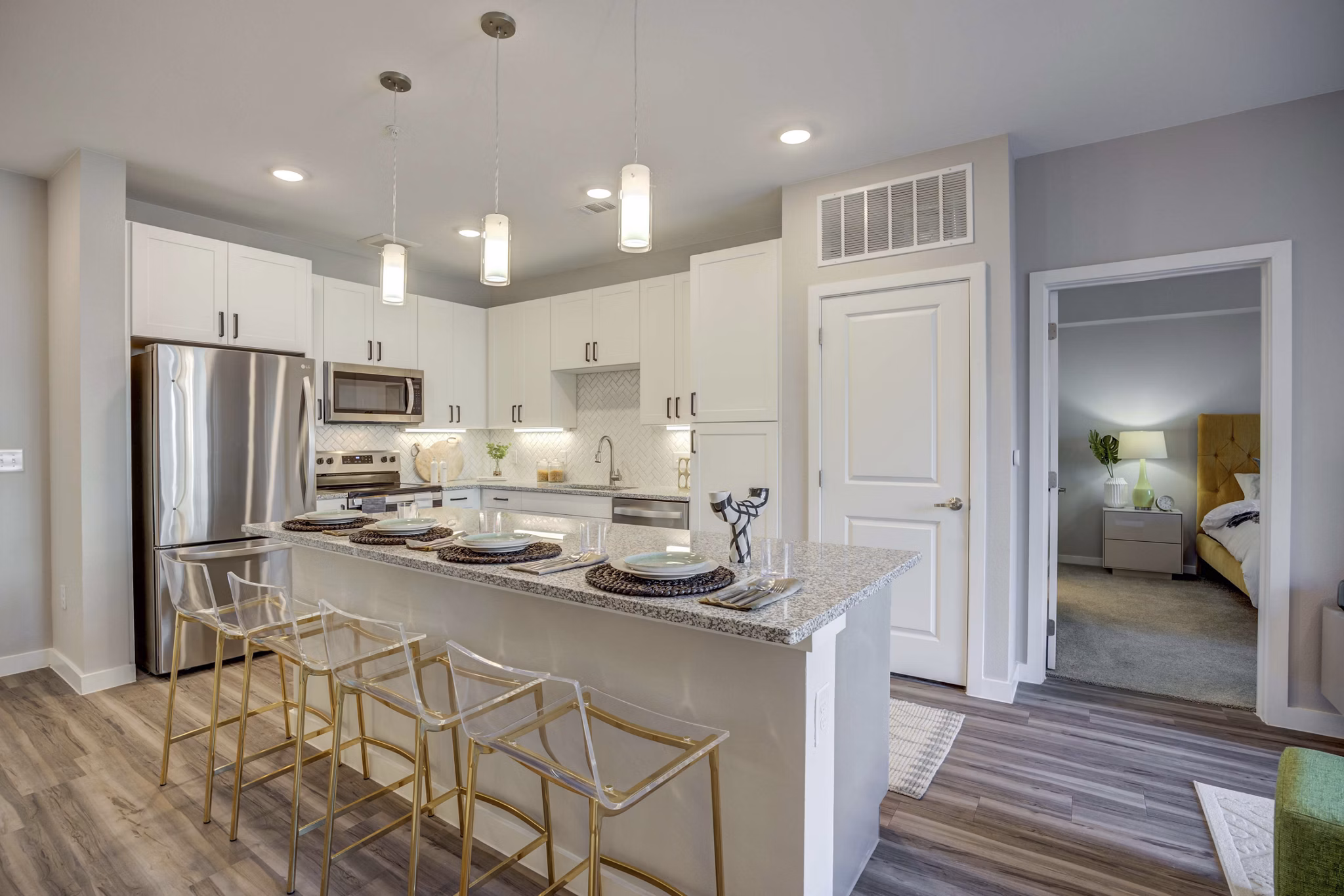 Modern kitchen with stainless steel appliances in Alder Apartments, featuring a sleek design and ample counter space