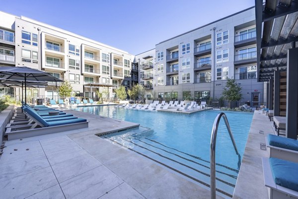 Alder Apartments: Luxurious pool area with city views offering a relaxing retreat for residents